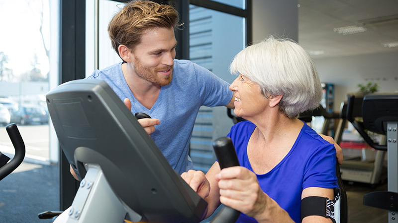 therapist with senior woman exercising 1